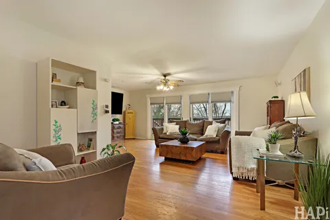 a living room with furniture and a wooden floor