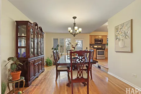a view of a dining room with furniture and chandelier