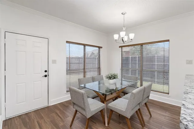 a dining room with furniture wooden floor and a chandelier