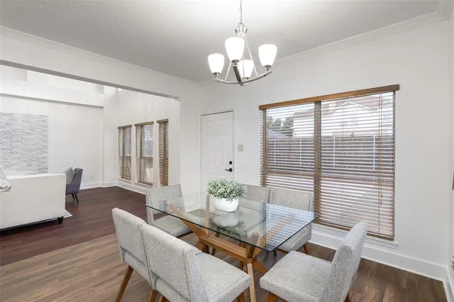 a view of a dining room with furniture wooden floor and chandelier