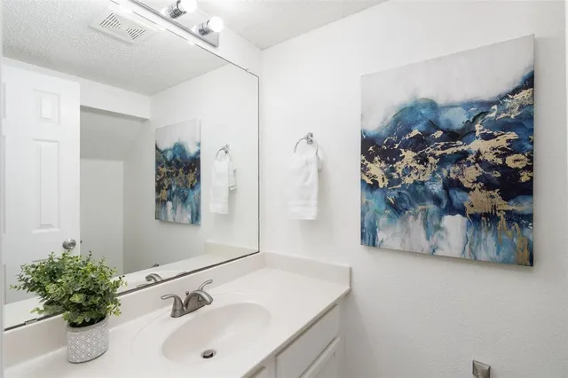 a bathroom with a sink and mirror