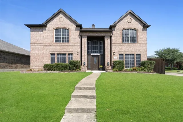 a front view of a house with a yard