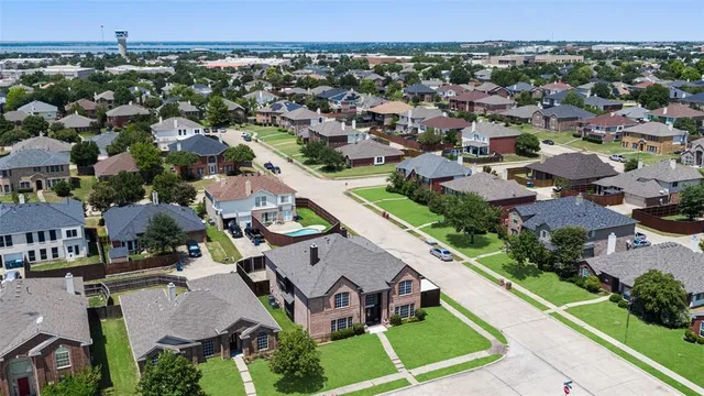 an aerial view of multiple houses with a yard