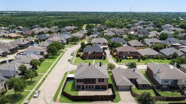 an aerial view of multiple houses with yard