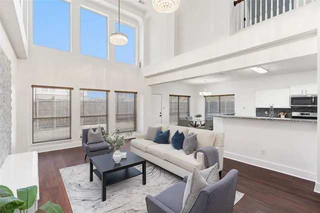 a living room with furniture and floor to ceiling windows