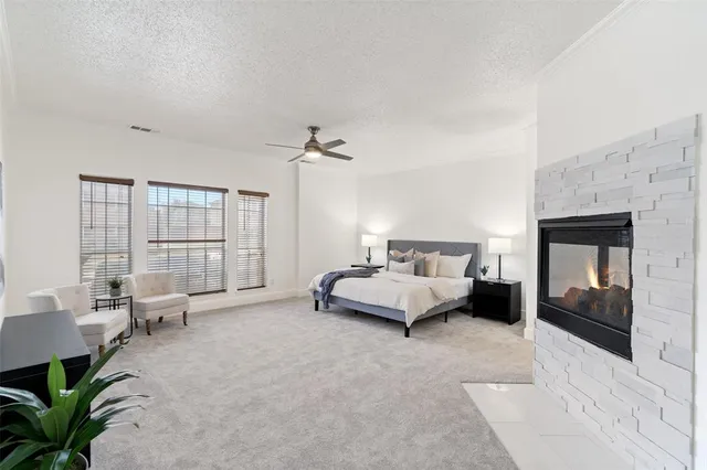 a spacious bedroom with a bed and large window