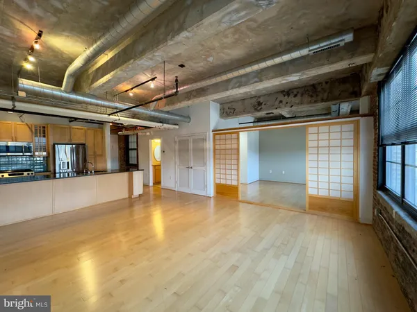 a view of an empty room with wooden floor