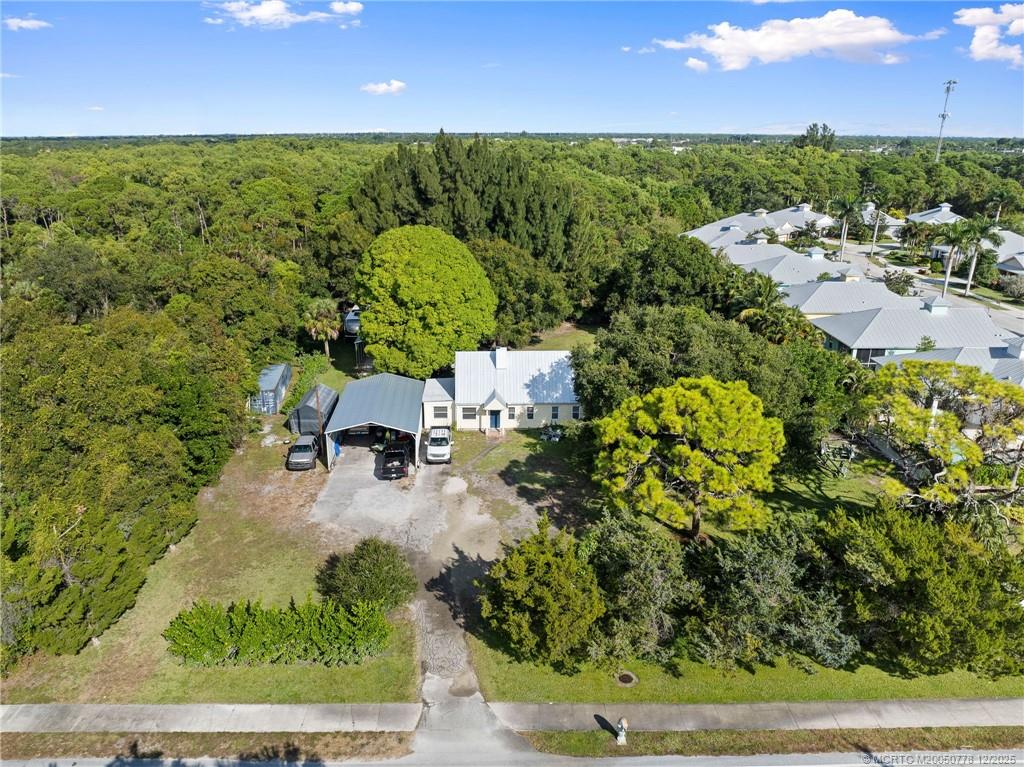 an aerial view of a house with a yard basket ball court and outdoor seating