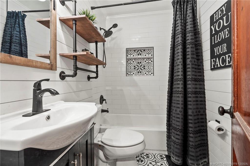 1699 Northwest Britt Road Stuart, FL 34994 - Photo 16 of 54 a bathroom with a sink a toilet and shower