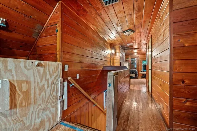a view of a room with wooden floor and iron fence