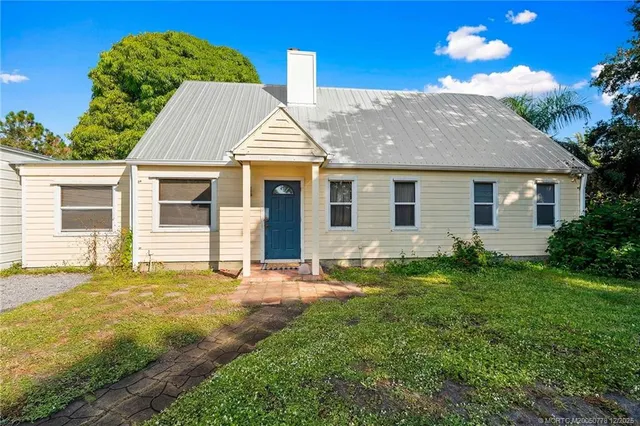 a view of backyard of house with green space
