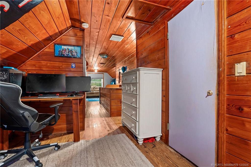 1699 Northwest Britt Road Stuart, FL 34994 - Photo 21 of 54 a view of a room with wooden floor and iron fence