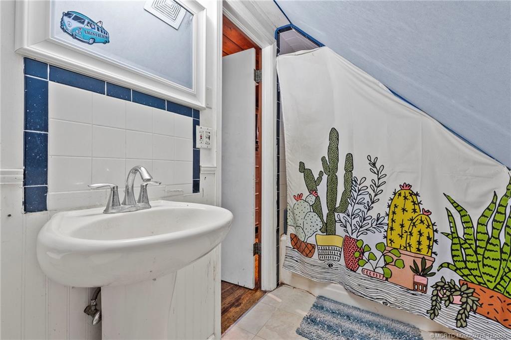 1699 Northwest Britt Road Stuart, FL 34994 - Photo 22 of 54 a bathroom with a sink and a mirror