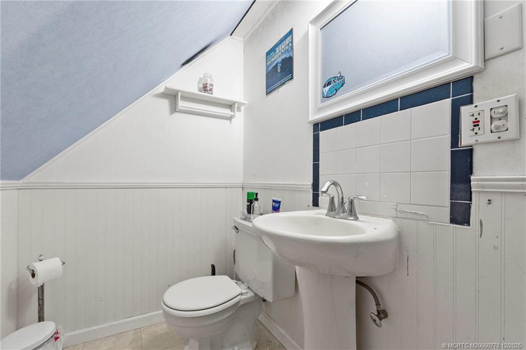 1699 Northwest Britt Road Stuart, FL 34994 - Photo 23 of 54 a bathroom with a sink toilet and a mirror