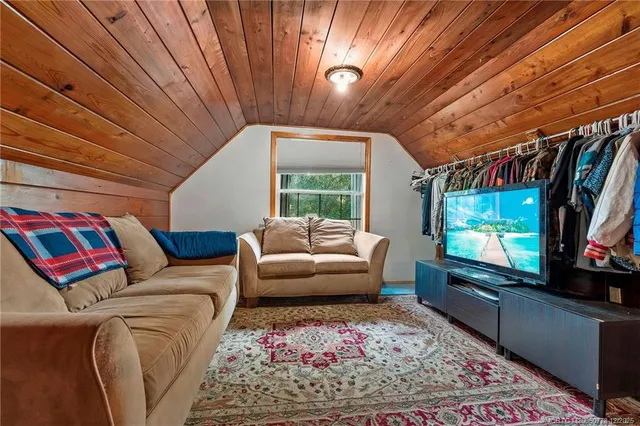 an aerial view of a house with a yard and lake view