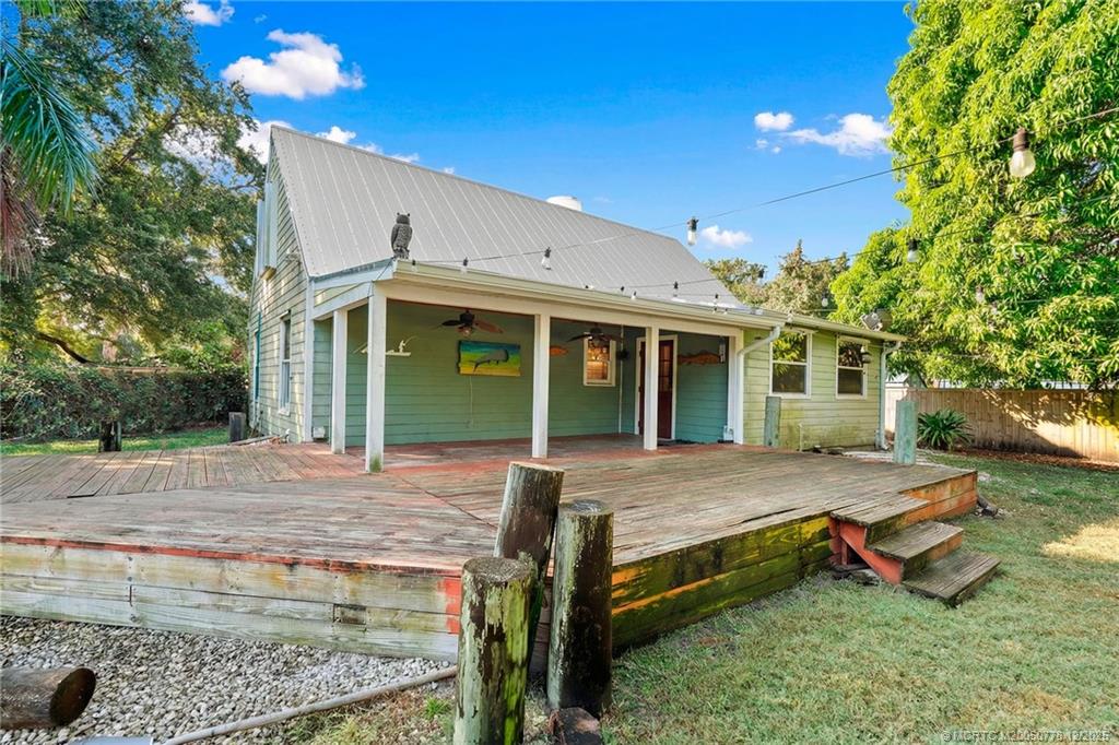 1699 Northwest Britt Road Stuart, FL 34994 - Photo 27 of 54 a view of a house with backyard and sitting area