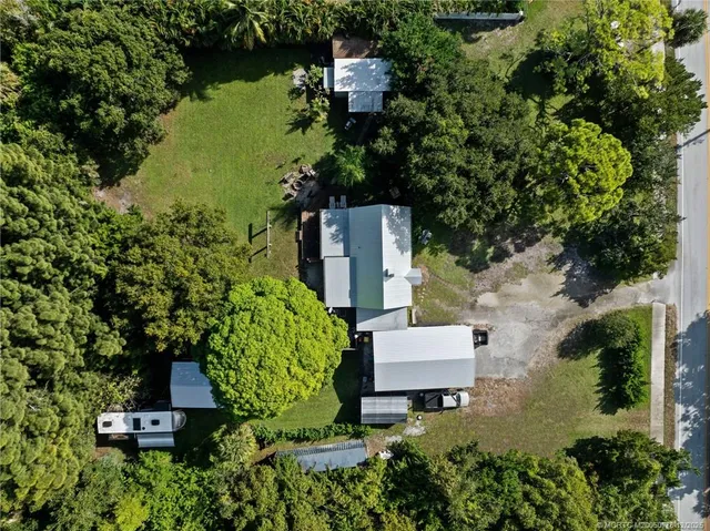 an aerial view of a house with a yard basket ball court and outdoor seating