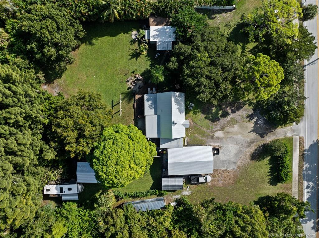 1699 Northwest Britt Road Stuart, FL 34994 - Photo 28 of 54 an aerial view of a house with a yard and lake view