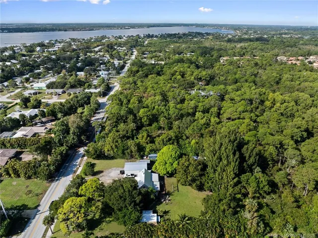 an aerial view of a house with a yard and lake view
