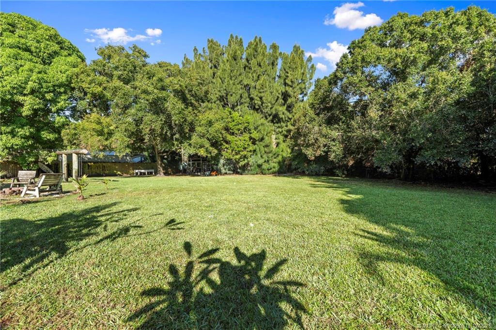 1699 Northwest Britt Road Stuart, FL 34994 - Photo 44 of 54 a view of outdoor space with deck and yard