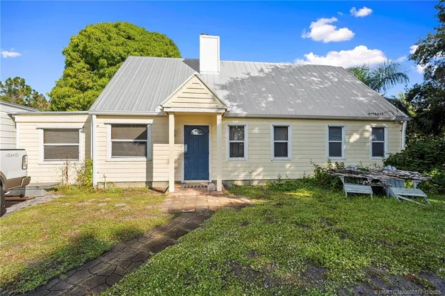 a view of a porch with furniture and a yard