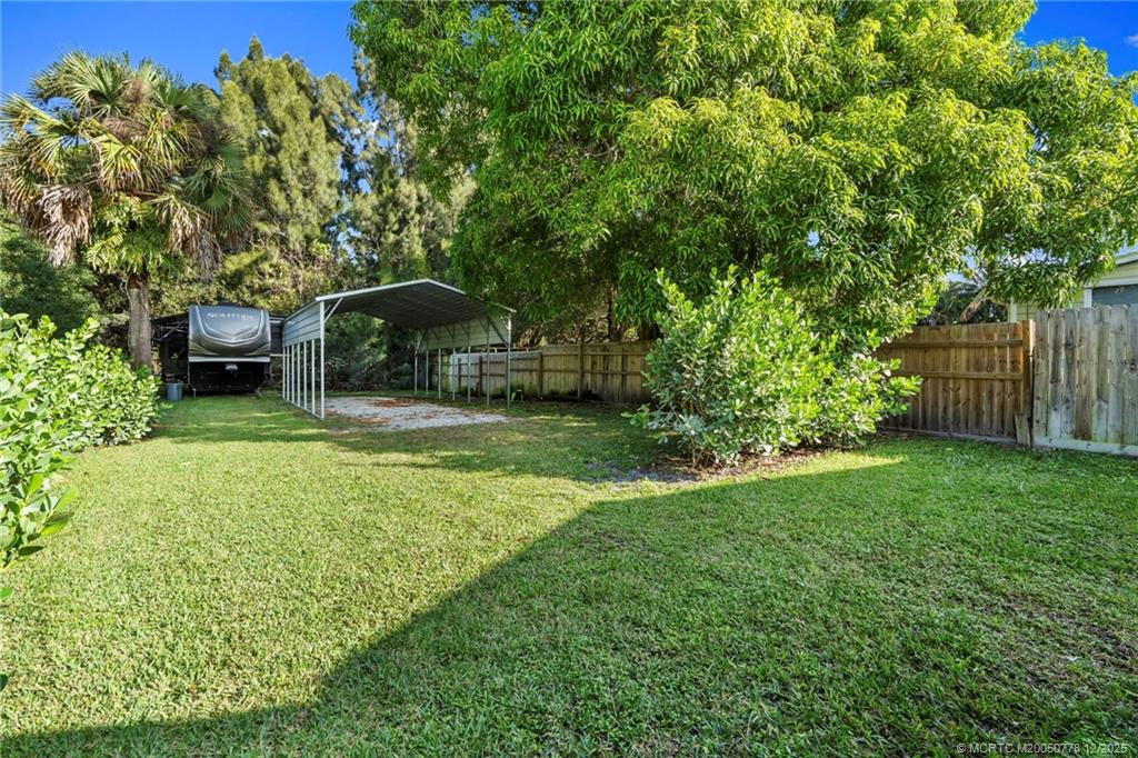 1699 Northwest Britt Road Stuart, FL 34994 - Photo 50 of 54 a backyard of a house with a garden and entertaining space