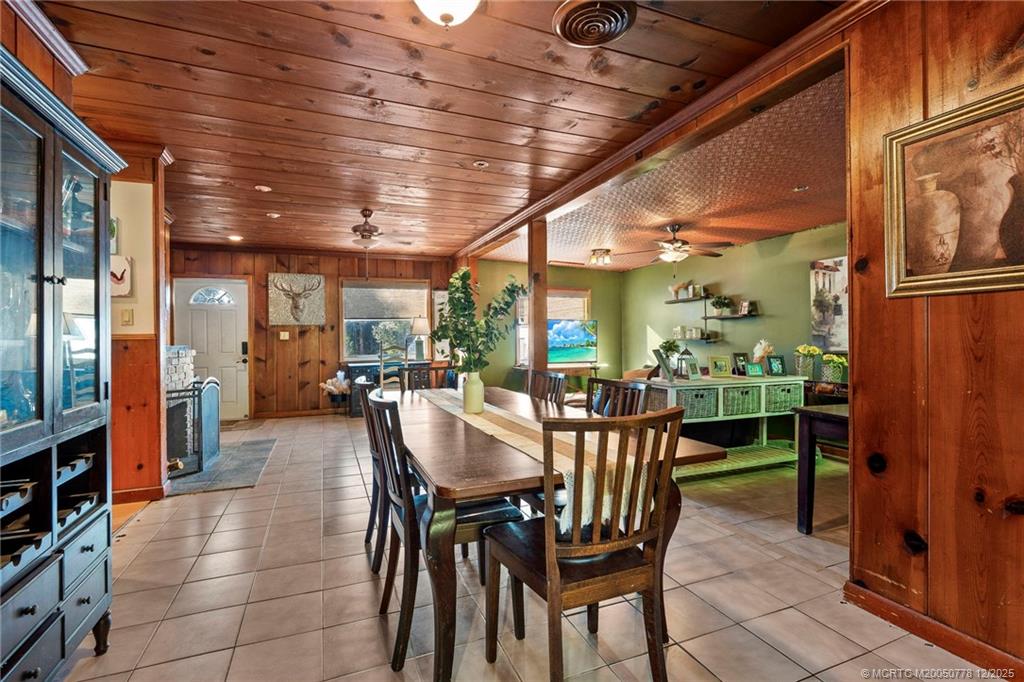 1699 Northwest Britt Road Stuart, FL 34994 - Photo 5 of 54 a dining room with furniture and a potted plant