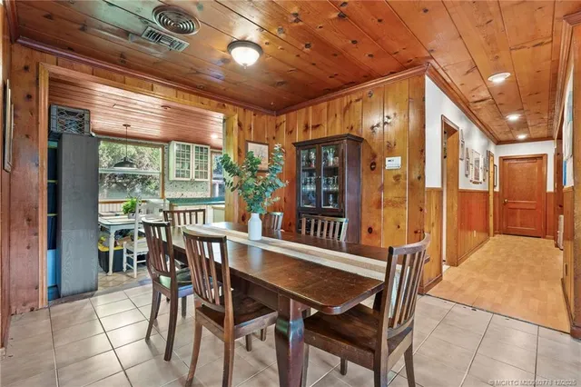 an empty room with windows & cabinet