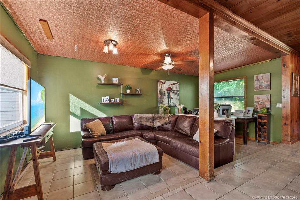 1699 Northwest Britt Road Stuart, FL 34994 - Photo 8 of 54 a living room with furniture and a large window