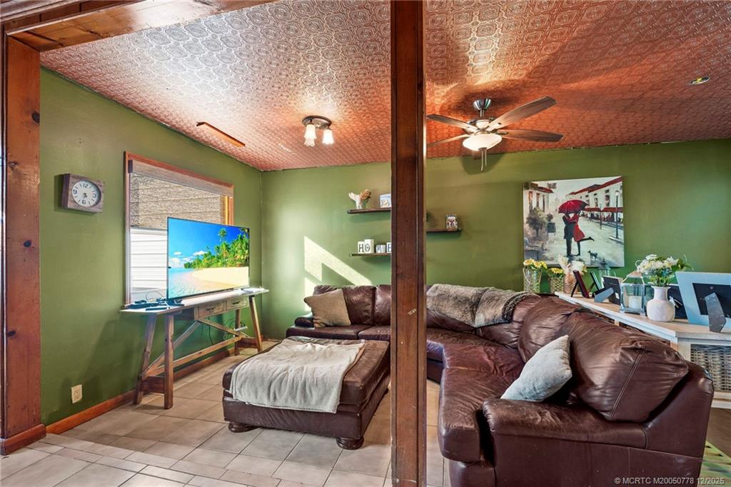 1699 Northwest Britt Road Stuart, FL 34994 - Photo 9 of 54 a living room with furniture and a flat screen tv