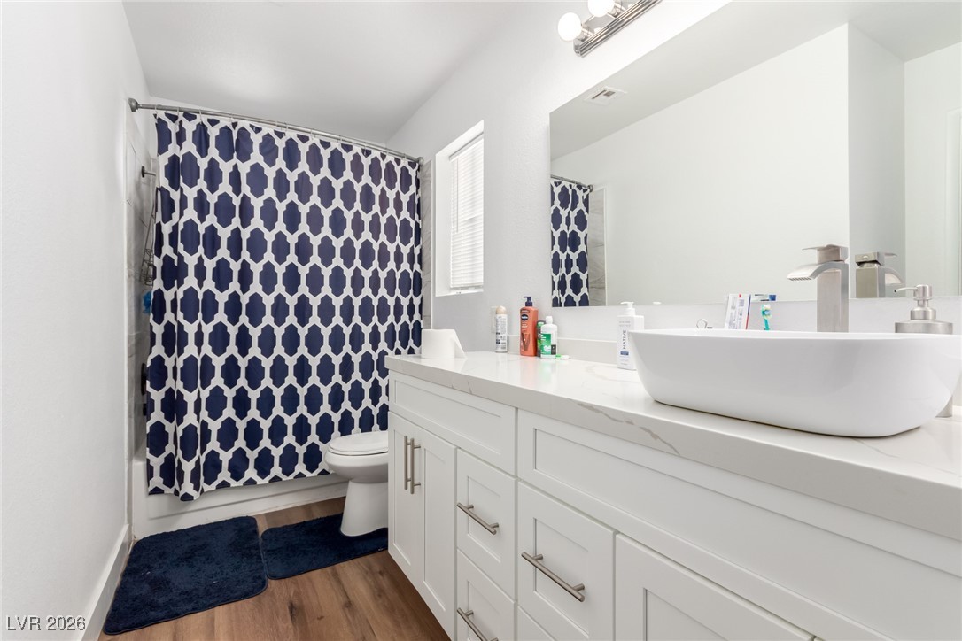 906 Ambusher Street Henderson, NV 89014 - Photo 24 of 38 Bathroom with vanity, dark wood-style flooring, and shower / bath combo