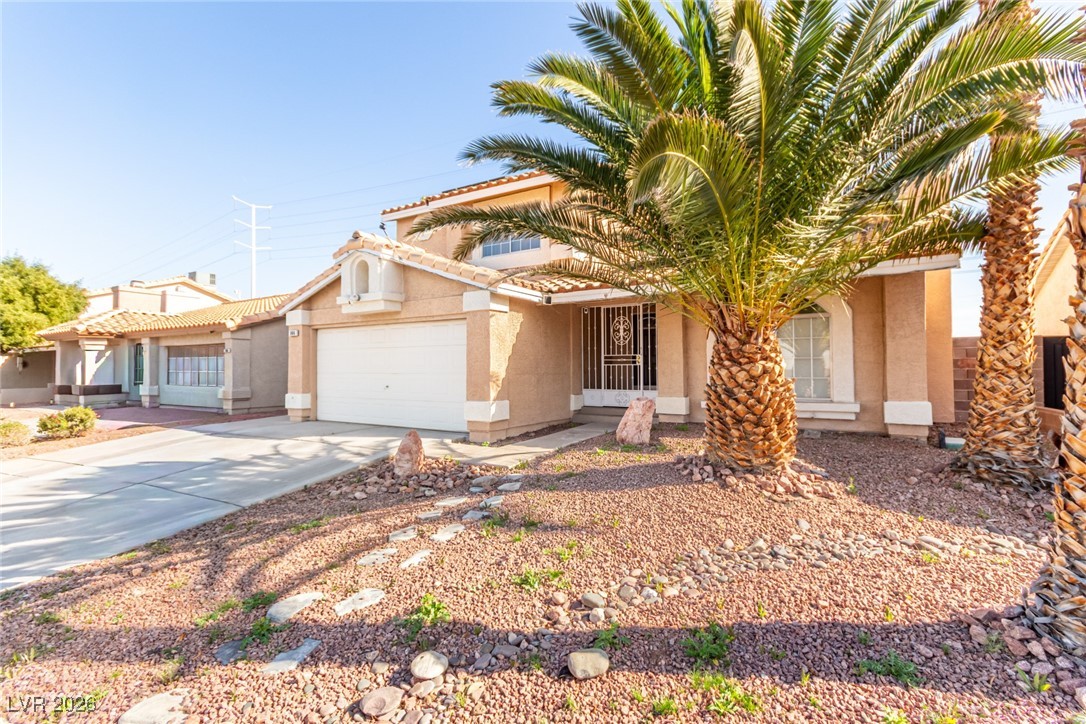 906 Ambusher Street Henderson, NV 89014 - Photo 30 of 38 Mediterranean / spanish-style house with stucco siding, driveway, and an attached garage