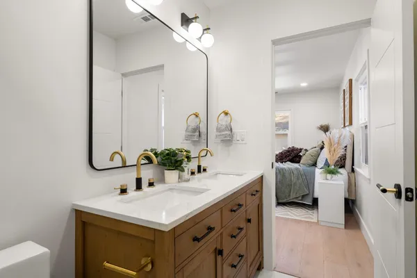 a bathroom with a sink a toilet and a shower