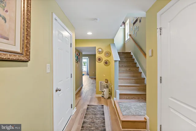 a view of a hallway with wooden floor and entryway
