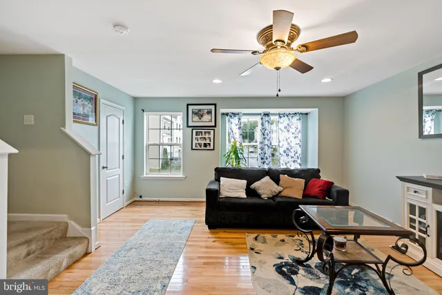 a living room with furniture ceiling fan and a rug