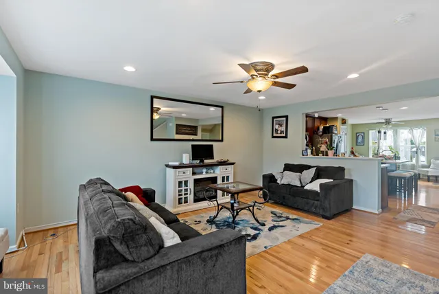 a living room with furniture ceiling fan and a rug