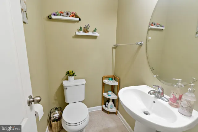 a bathroom with a sink mirror and toilet
