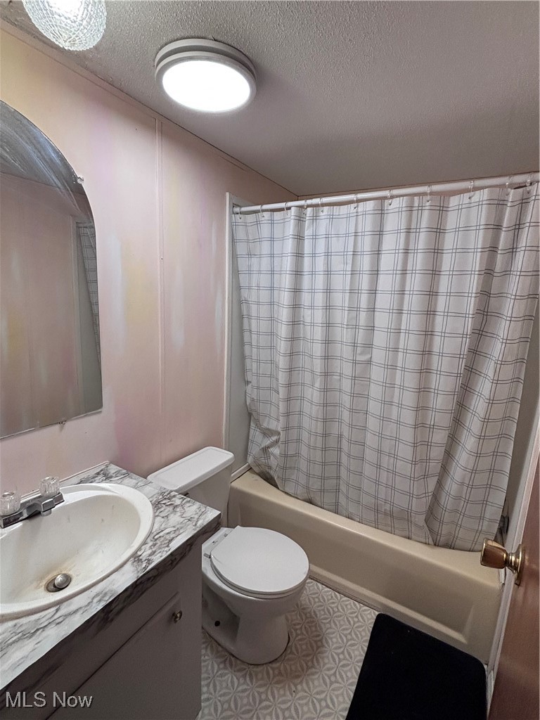 29311 Rabbit Ridge Road Howard, OH 43028 - Photo 12 of 39 Full bathroom with shower / tub combo with curtain, vanity, a textured ceiling, and light flooring