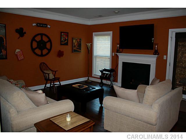 1032 Ridgehaven Road Waxhaw, NC 28173 - Photo 4 of 16 a living room with furniture a flat screen tv and a fireplace