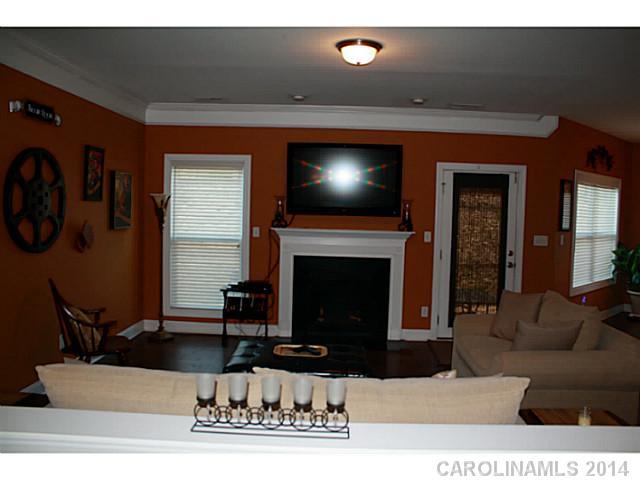 1032 Ridgehaven Road Waxhaw, NC 28173 - Photo 5 of 16 a living room with furniture a fireplace and flat screen tv