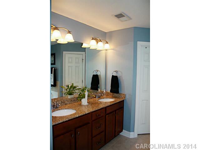 1032 Ridgehaven Road Waxhaw, NC 28173 - Photo 9 of 16 a bathroom with a double vanity sink and a mirror