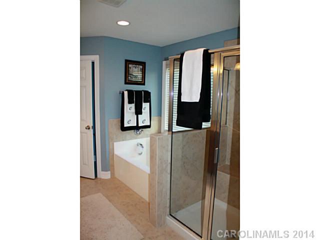 1032 Ridgehaven Road Waxhaw, NC 28173 - Photo 10 of 16 a en suite bathroom with a sink and mirror
