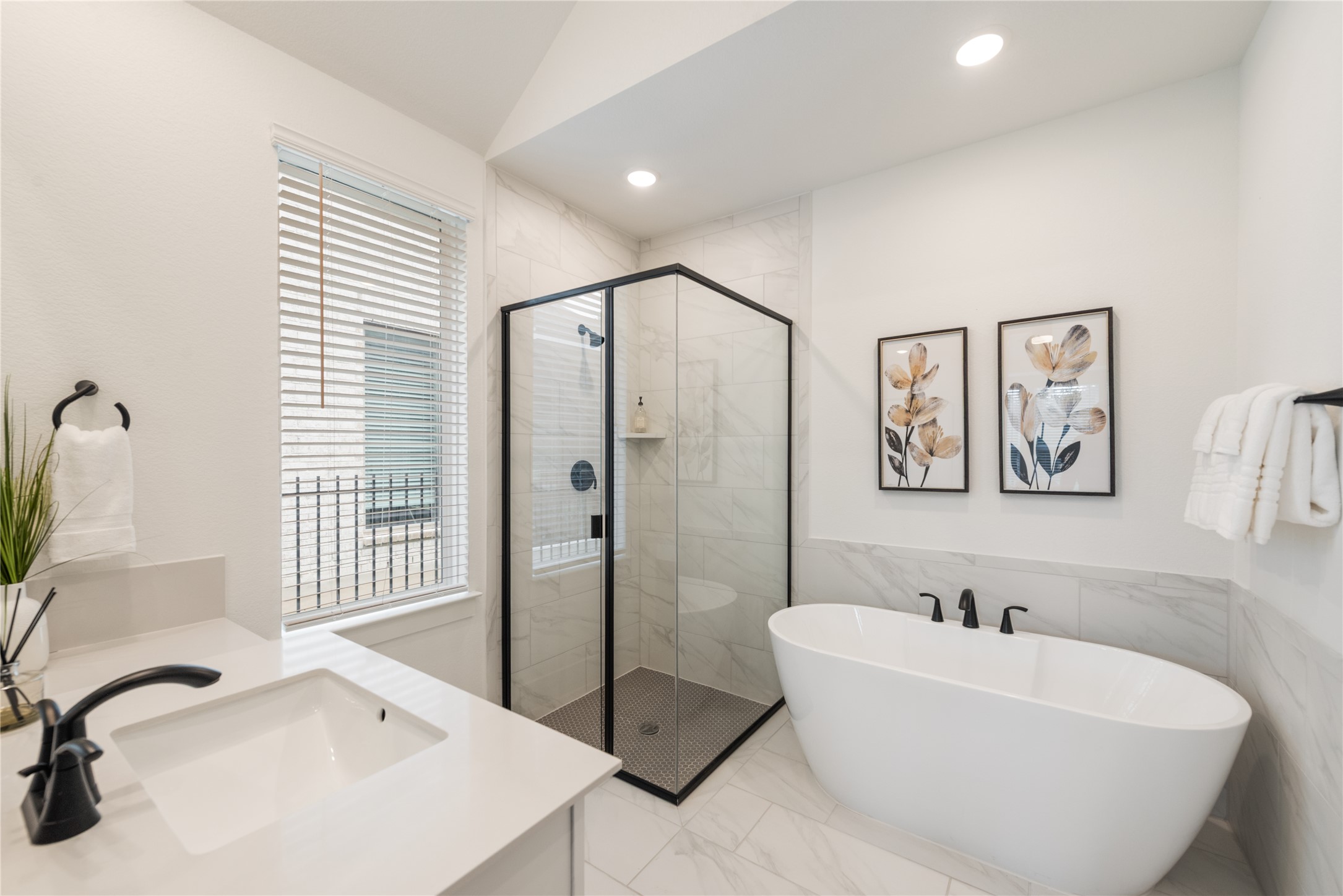 294 Kimble Creek Loop Kyle, TX 78640 - Photo 18 of 40 Luxurious soaking tub and sleek glass-enclosed shower create a rejuvenating bath space.