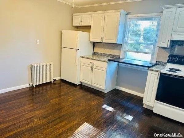 a kitchen with a refrigerator and a stove top oven