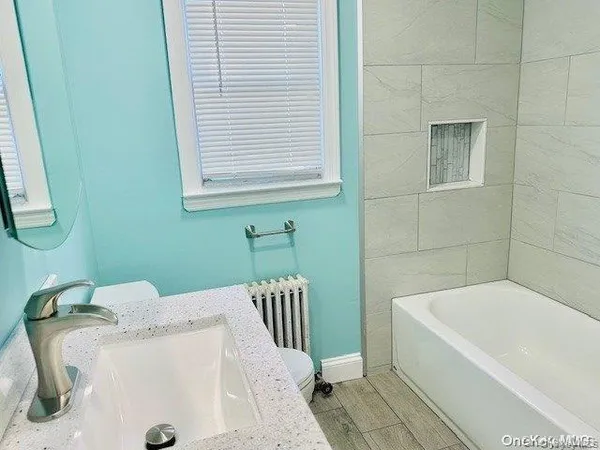 a bathroom with a bathtub and a sink