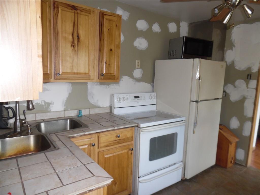1276 Glades Pike Somerset, PA 15501 - Photo 15 of 32 a kitchen with a refrigerator sink and cabinets
