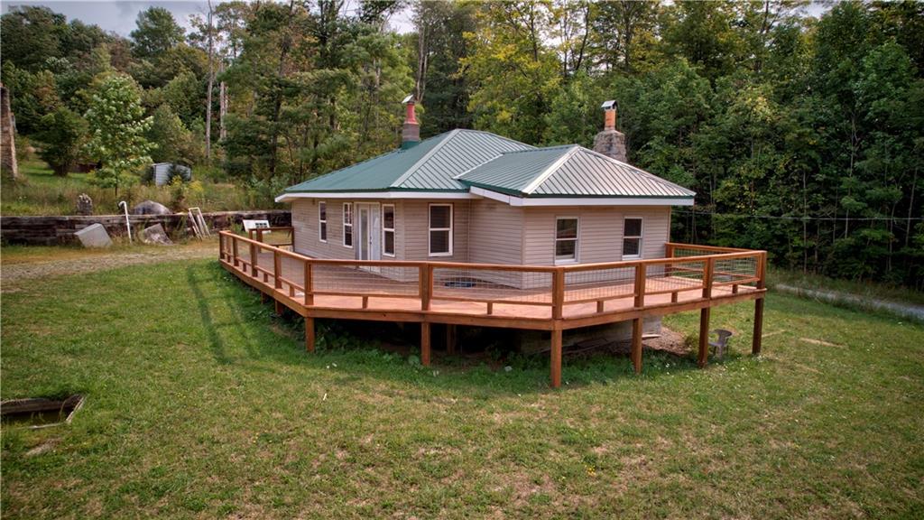 1276 Glades Pike Somerset, PA 15501 - Photo 2 of 32 a front view of a house with a wooden deck and a yard