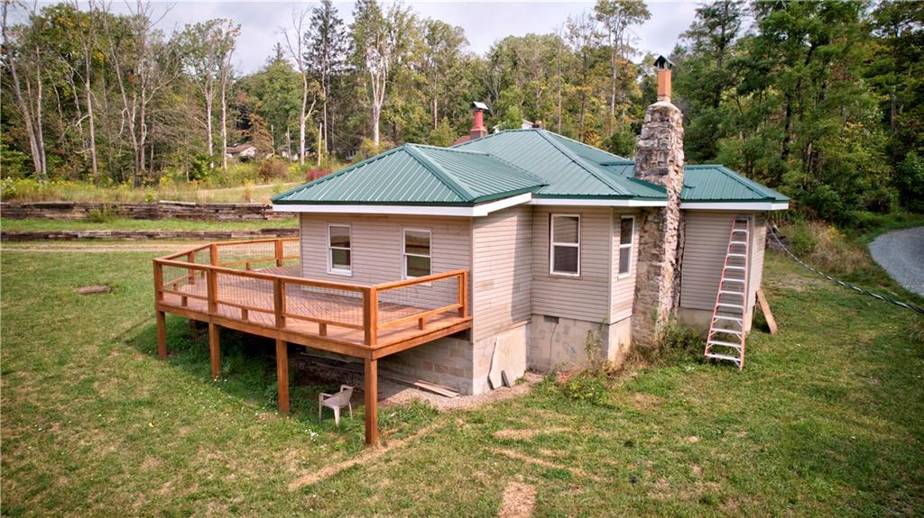 1276 Glades Pike Somerset, PA 15501 - Photo 4 of 32 a backyard of a house with wooden deck and furniture