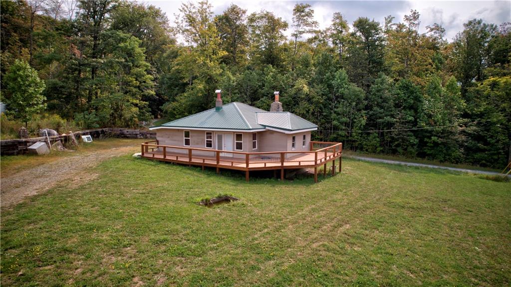1276 Glades Pike Somerset, PA 15501 - Photo 5 of 32 a wooden deck with trees in the background