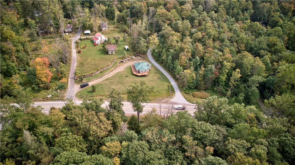 1276 Glades Pike Somerset, PA 15501 - Photo 6 of 32 an aerial view of a house with a yard and large trees
